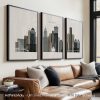 Three framed art prints depicting the skyline of Detroit with various buildings and structures.