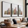 Three framed art prints of Detroit's skyline with various architectural features and colors.