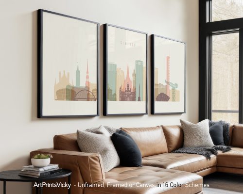 Three framed prints of Glasgow's cityscape displayed on a wall above a couch.