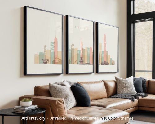 Three framed art prints depicting a stylized cityscape of Hong Kong in muted colors.