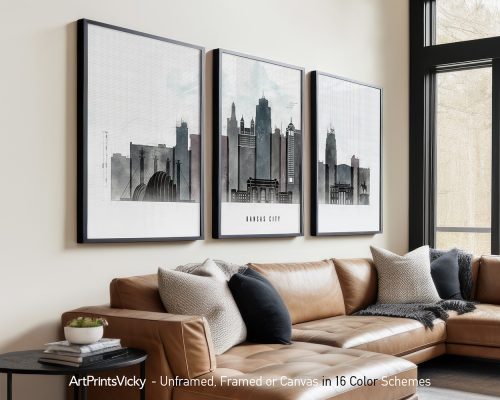 Three framed art prints of the Kansas City skyline displayed on a wall above a couch.