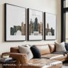 Three framed art prints depicting the skyline of Kansas City in muted colors.