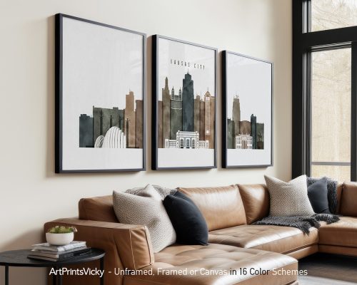 Three framed art prints depicting the skyline of Kansas City in muted colors.