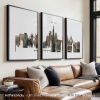 Three framed prints of a London cityscape displayed on a wall above a sofa.