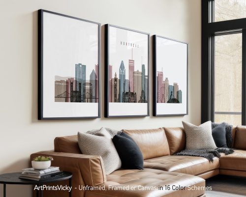 Three framed art prints of Montreal's skyline displayed on a wall above a couch.