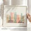 Framed artwork depicting a stylized cityscape of Montreal with various buildings and colors.