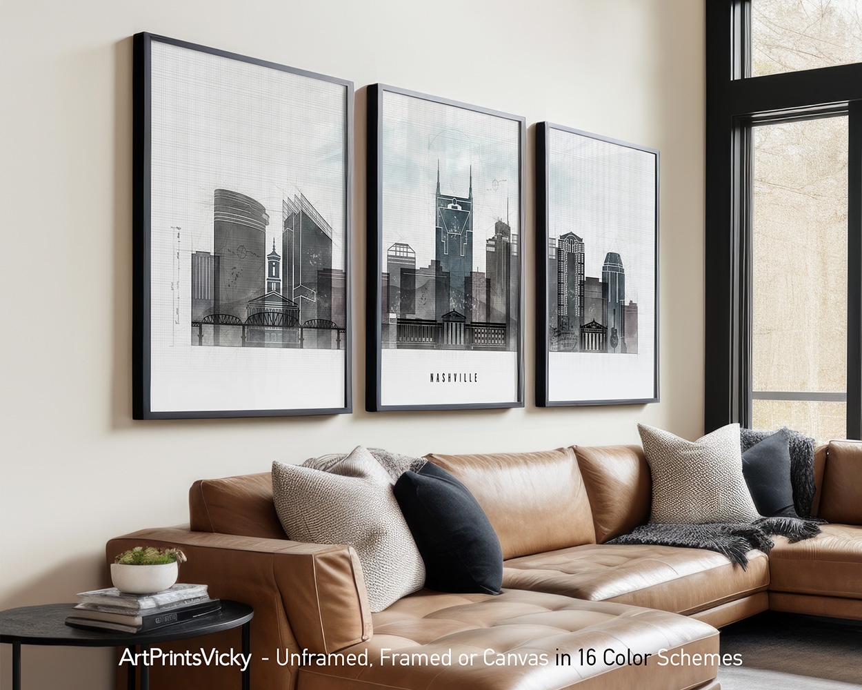 Three framed art prints of Nashville's skyline displayed on a wall above a couch.