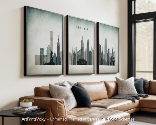 Three framed art prints depicting a stylized skyline of New York City with various buildings.