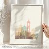 Framed artwork depicting a stylized illustration of Nice with pastel colors and architectural elements.