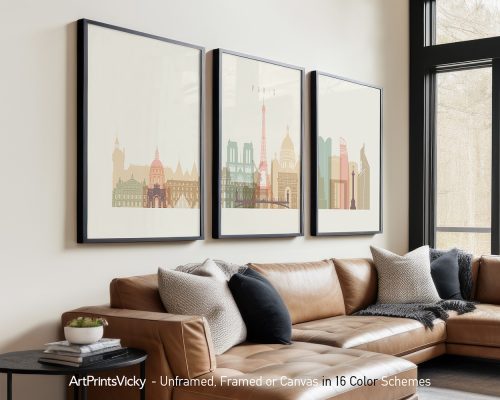 Three framed art prints of Paris landmarks displayed on a wall above a sofa.