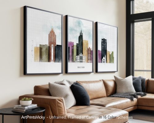 Three framed art prints depicting a cityscape of Raleigh with various buildings in different colors.