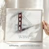 Framed artwork depicting the Golden Gate Bridge in San Francisco with a soft background.