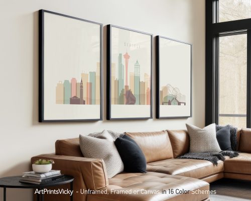 Three framed art prints depicting a stylized cityscape of Seattle with notable landmarks.