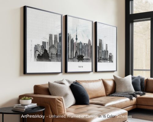 Three framed art prints of Tokyo cityscape displayed on a wall above a sofa.