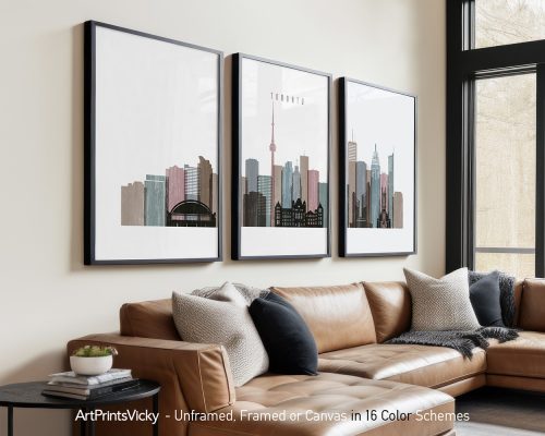 Three framed art prints of the Toronto skyline displayed on a wall above a couch.