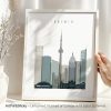 Framed cityscape print of Toronto featuring notable buildings and the CN Tower.