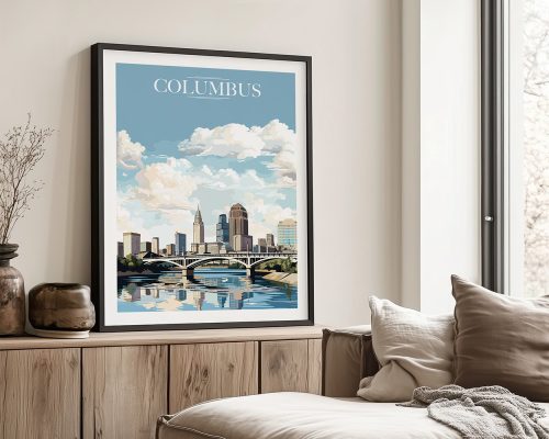 Framed artwork featuring a cityscape of Columbus with a river and clouds in the background.