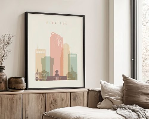 Framed artwork depicting a pastel-colored cityscape of Winnipeg with various buildings.