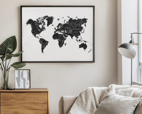 Black and white world map framed and displayed on a wall with indoor decor elements.
