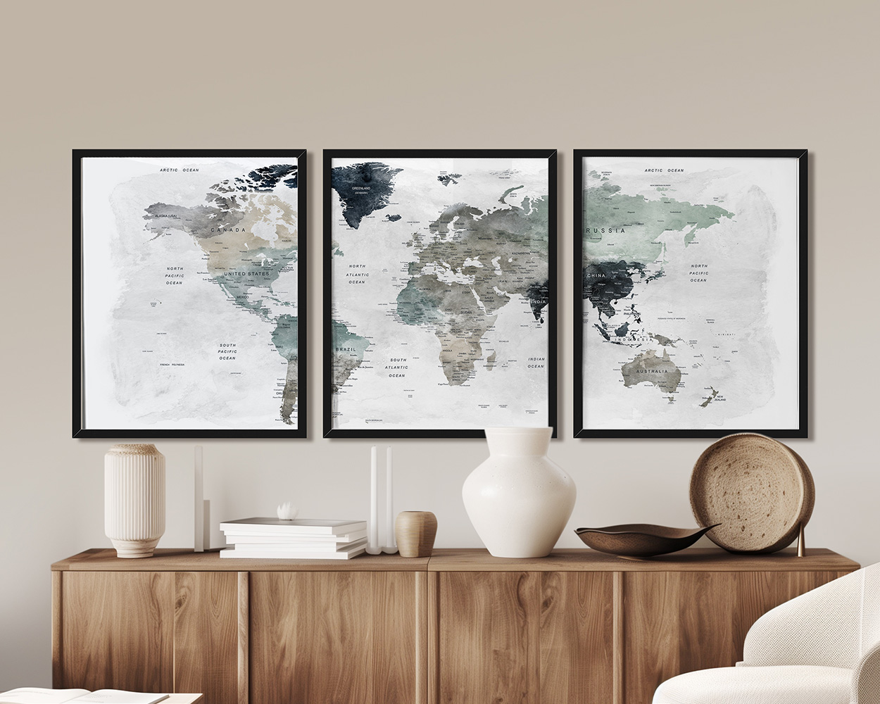 Three framed world maps displayed on a wooden surface with decorative items.