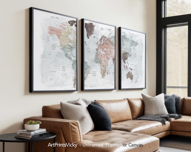 Three framed world maps in pastel tones displayed on a wall above a sofa.