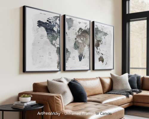 Three framed maps of the world in neutral colors displayed on a wall above a sofa.